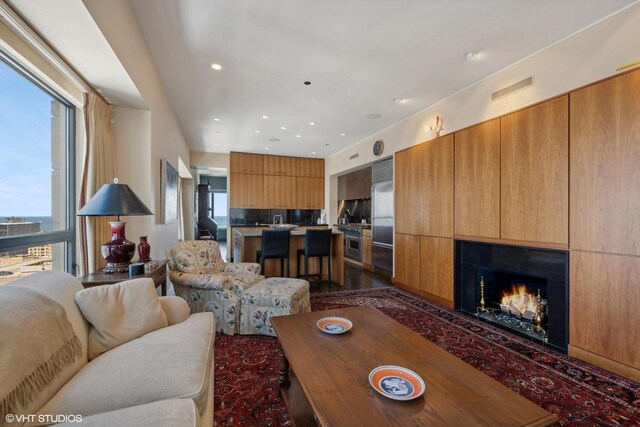 living room featuring dark hardwood / wood-style flooring and a wealth of natural light