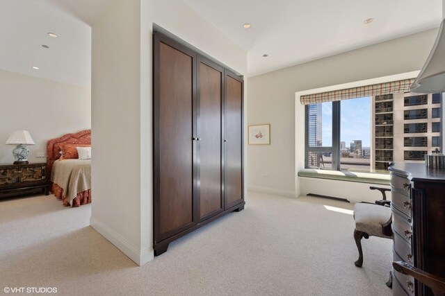 bedroom with light colored carpet and a closet