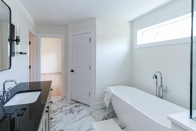 bathroom featuring vanity, wood-type flooring, and a tub