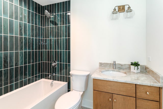 full bathroom with toilet, vanity, and tiled shower / bath