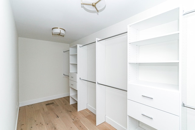 walk in closet featuring light hardwood / wood-style floors