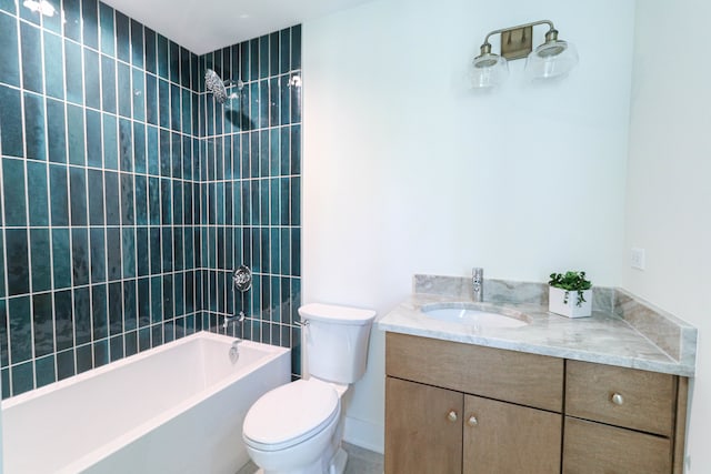 full bathroom with toilet, tiled shower / bath combo, and vanity