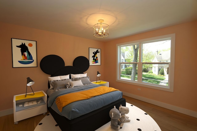 bedroom with wood-type flooring and a chandelier