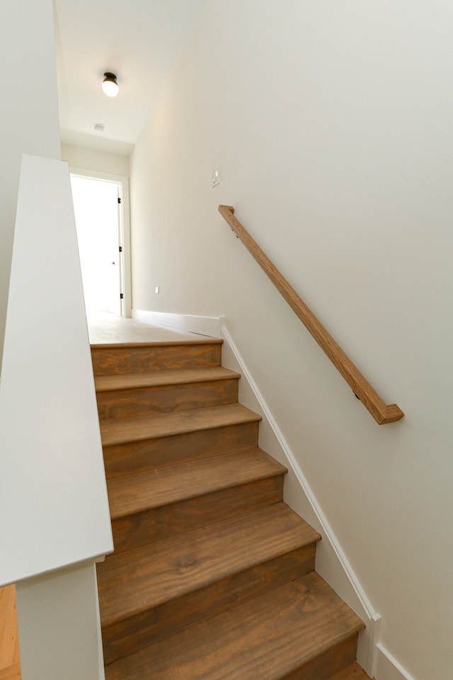 staircase with hardwood / wood-style floors