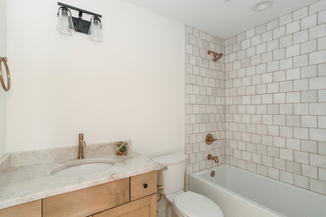 full bathroom featuring toilet, vanity, and tiled shower / bath