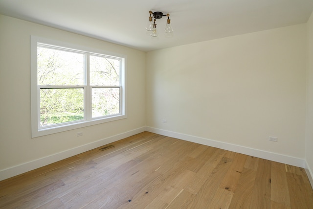 empty room with light hardwood / wood-style flooring