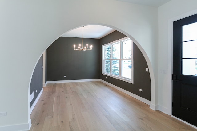 interior space featuring an inviting chandelier and light wood-type flooring