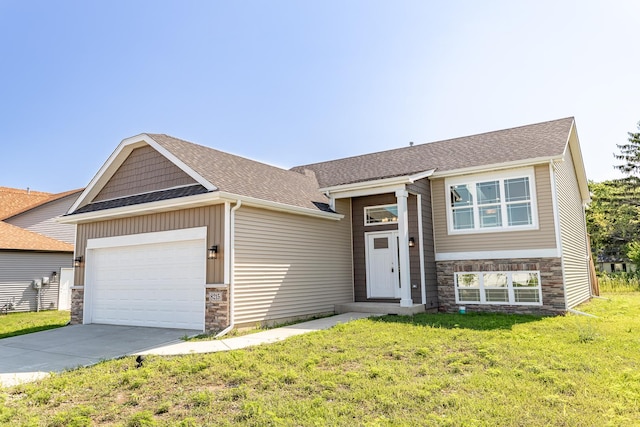 view of front of house with a garage, a shingled roof, concrete driveway, stone siding, and a front lawn