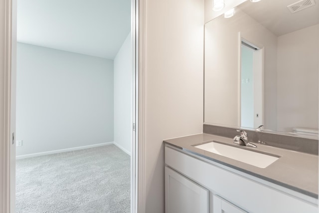 half bathroom featuring toilet, baseboards, visible vents, and vanity