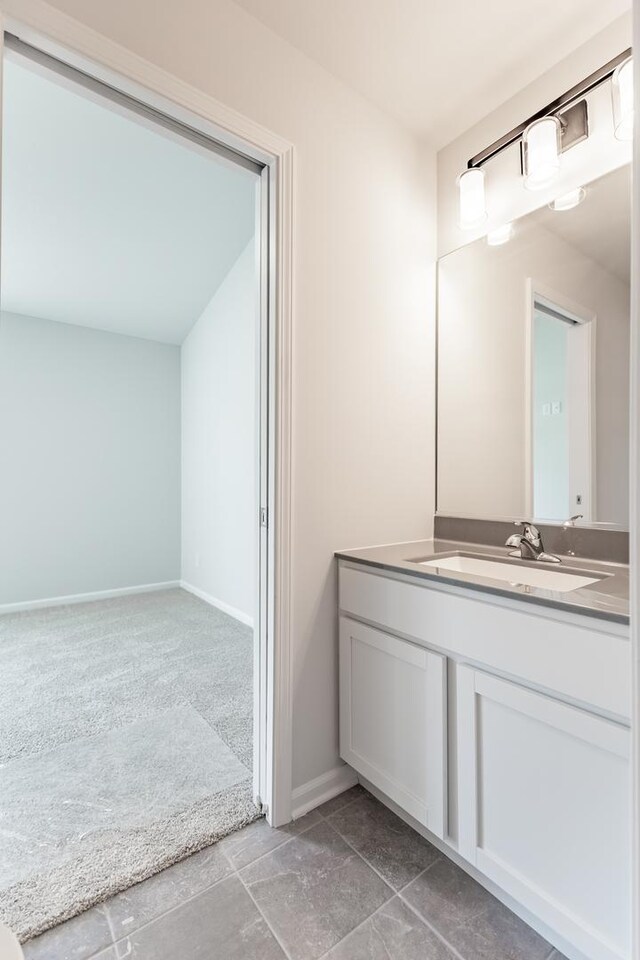 bathroom with vanity and baseboards