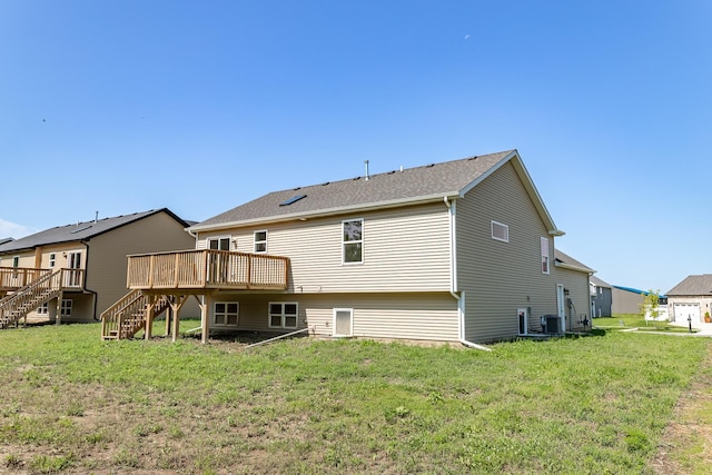 rear view of house with a deck, a lawn, stairway, and central air condition unit