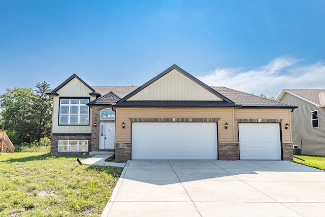 view of front of house featuring a garage and a front lawn