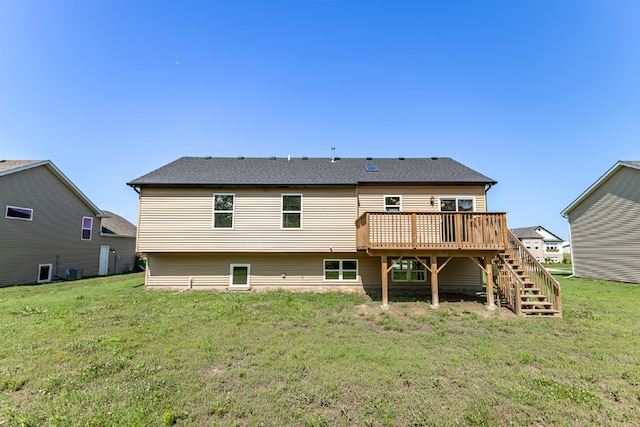 rear view of property featuring central air condition unit, stairway, a deck, and a lawn