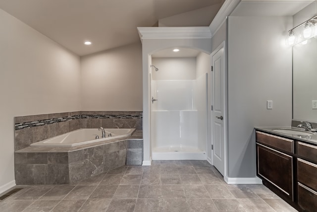 bathroom featuring a shower, a garden tub, vanity, and baseboards