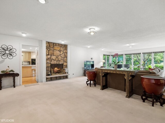 bar with a fireplace, light carpet, and a textured ceiling