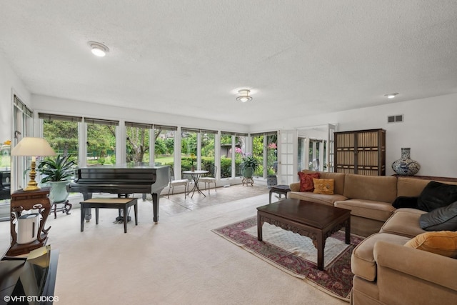 living room with light carpet and a textured ceiling