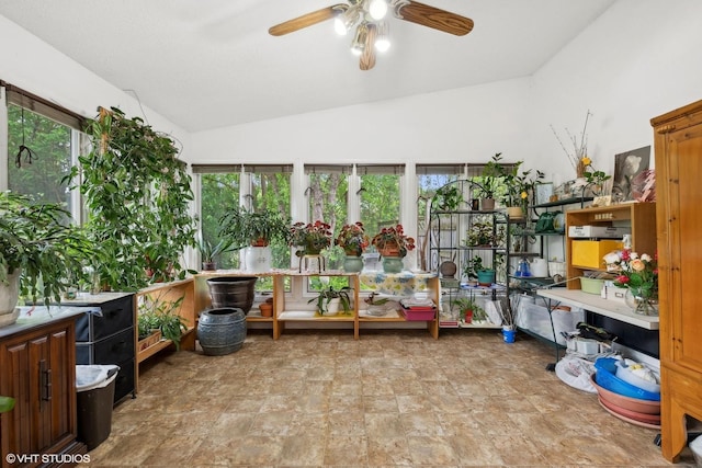 sunroom / solarium with ceiling fan, vaulted ceiling, and a healthy amount of sunlight