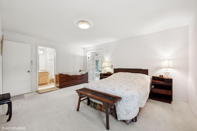 carpeted bedroom featuring ensuite bath