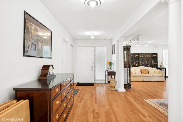 foyer with ornate columns and light hardwood / wood-style flooring