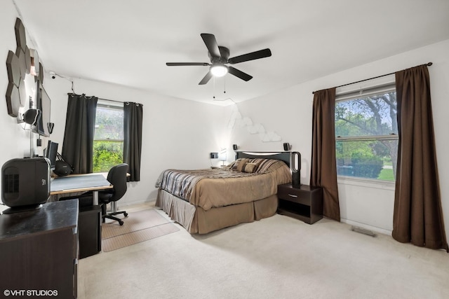 bedroom featuring ceiling fan and light carpet