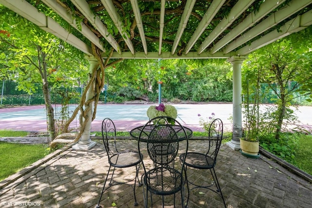 view of patio featuring tennis court