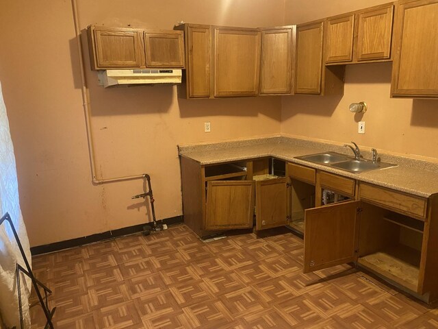 kitchen featuring sink and dark parquet flooring