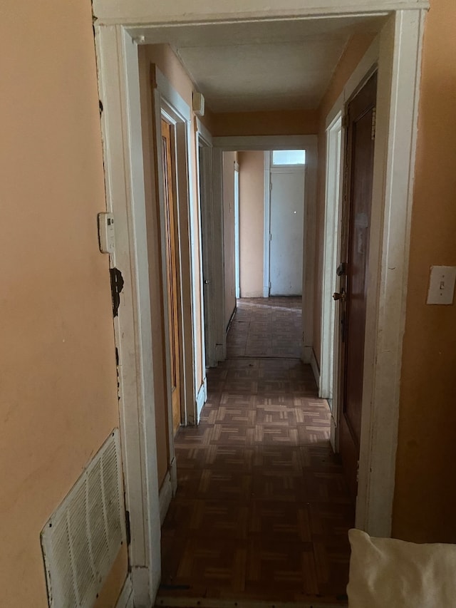 hallway with dark parquet floors