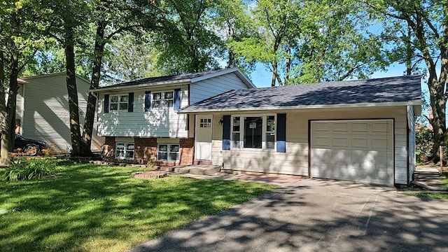 tri-level home featuring a garage and a front lawn