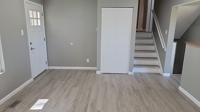 foyer entrance with light hardwood / wood-style floors