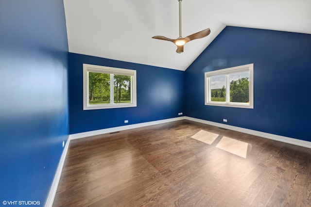 spare room featuring ceiling fan, vaulted ceiling, hardwood / wood-style floors, and a healthy amount of sunlight