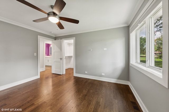 unfurnished bedroom featuring ceiling fan, a closet, dark hardwood / wood-style flooring, and a spacious closet