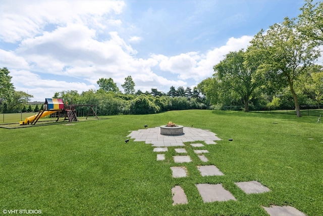 view of yard featuring a playground and a fire pit