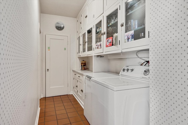 laundry room featuring cabinets and tile patterned floors