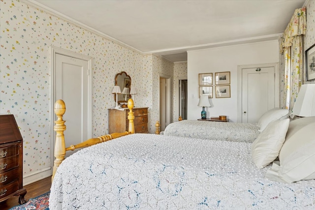 bedroom with ornamental molding and hardwood / wood-style flooring