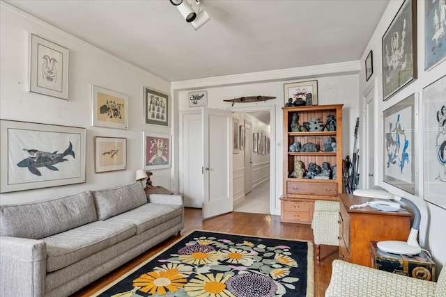 living room featuring crown molding and wood-type flooring