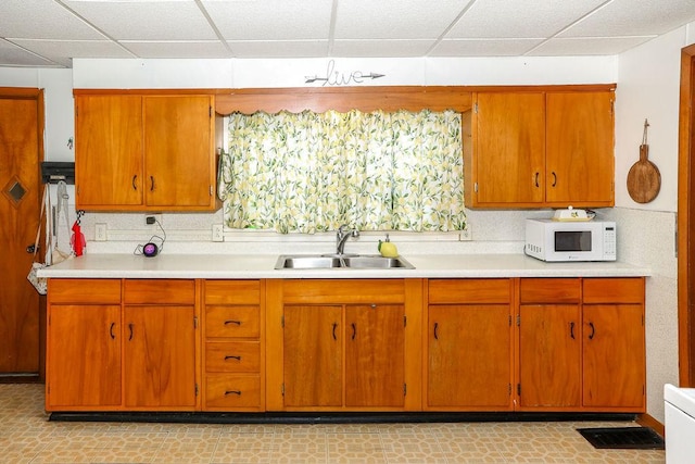 kitchen with sink and a paneled ceiling