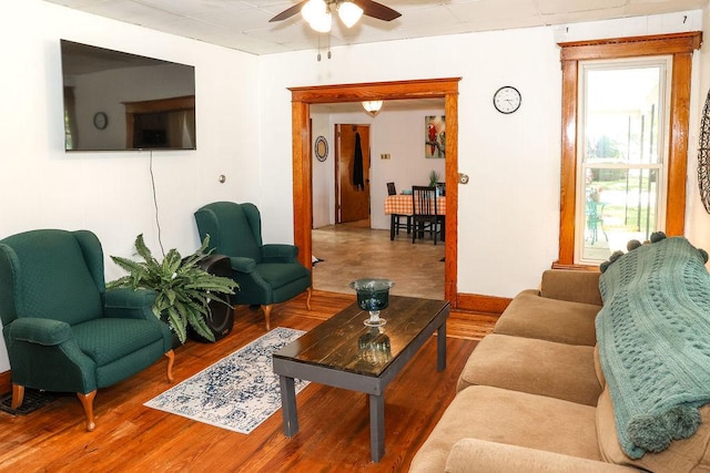 living room featuring wood-type flooring and ceiling fan