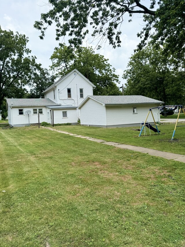 back of property with a yard, a porch, and cooling unit