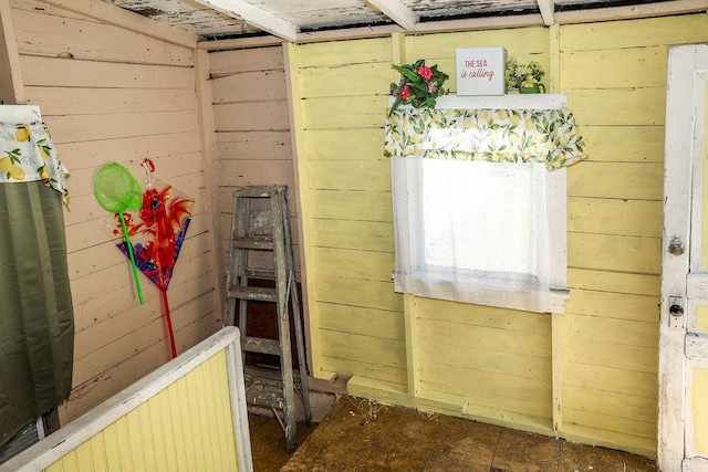 interior space featuring wooden walls