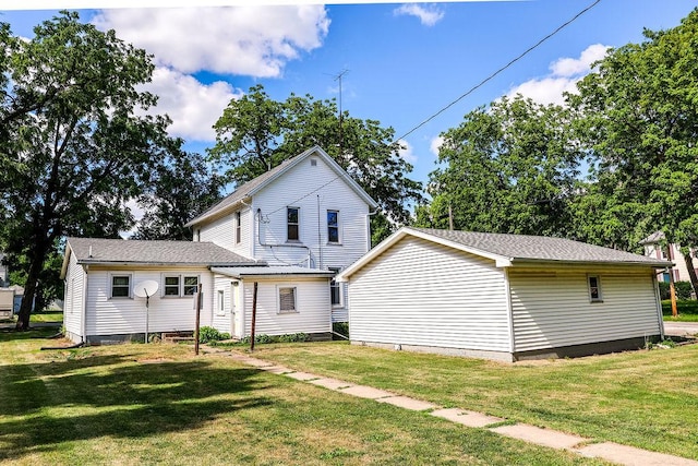 rear view of property with a yard