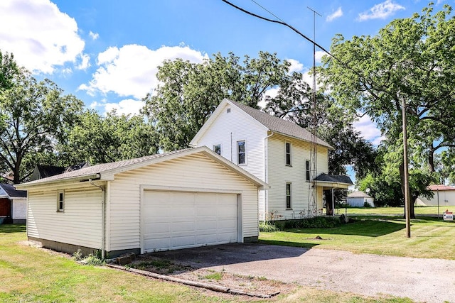 view of side of home with an outbuilding, a garage, and a lawn