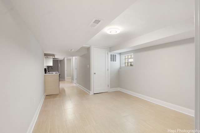 interior space featuring sink and light hardwood / wood-style flooring