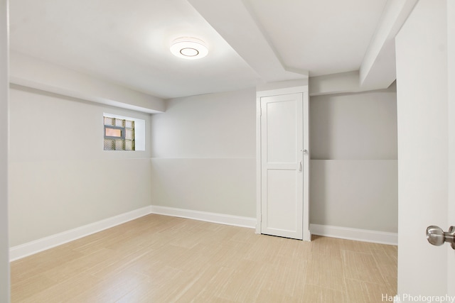 basement with light hardwood / wood-style floors