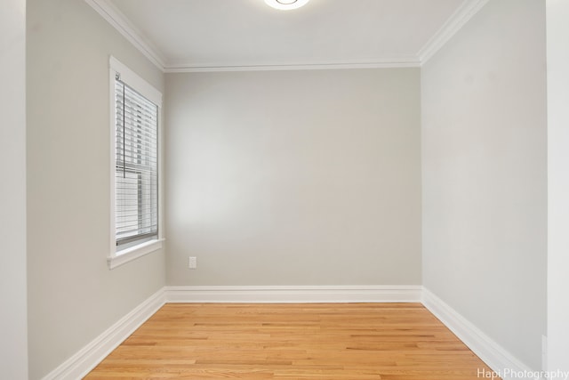 empty room featuring light hardwood / wood-style floors and ornamental molding