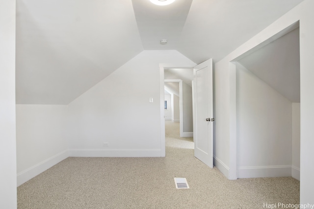 additional living space with light carpet and lofted ceiling