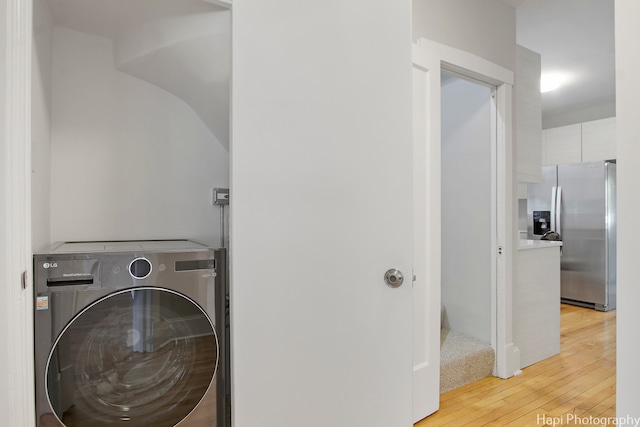 laundry area featuring washer / dryer and light hardwood / wood-style floors