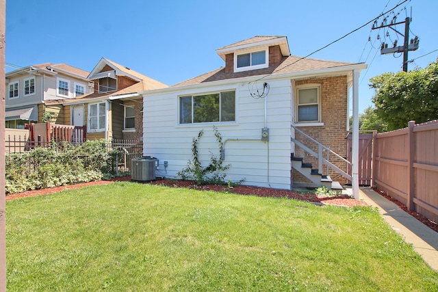 exterior space with cooling unit and a front lawn