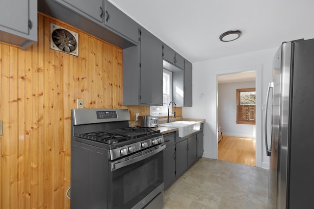 kitchen with gray cabinets, sink, and stainless steel appliances