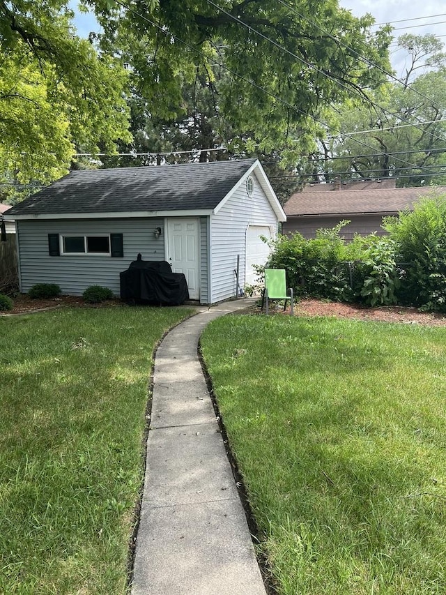 exterior space featuring a garage and a yard