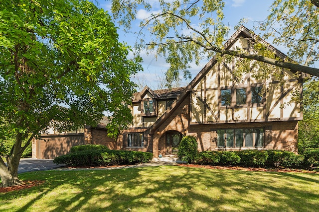 english style home featuring a front lawn